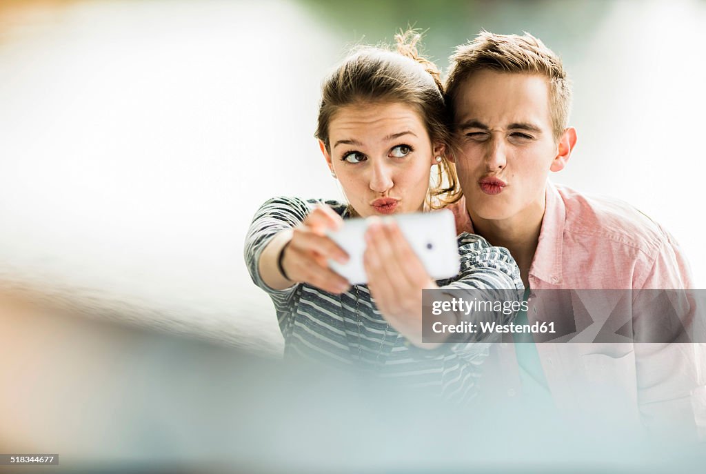 Young couple taking a selfie with smartphone