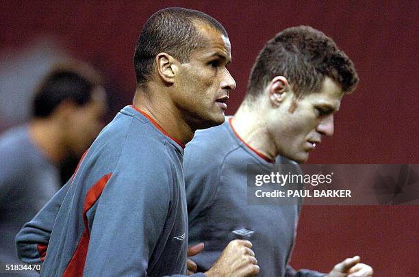 Olympiacos CFP's Brazilian midfielder Vitor Rivaldo and Argentinean striker Gabriel Schurrer run during a training session on the eve of the...