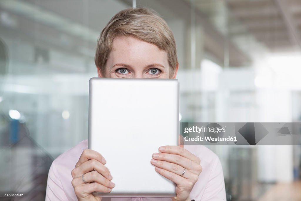 Germany, Munich, Businesswoman in office, using digital tablet