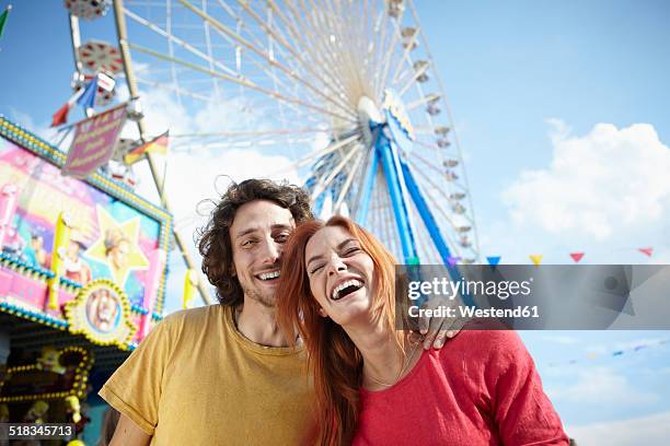 happy young couple on a funfair - noria fotografías e imágenes de stock