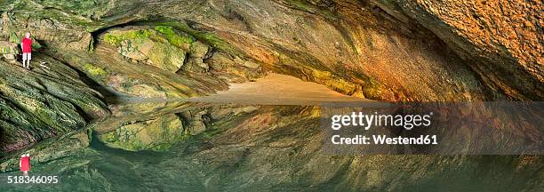 new zealand, golden bay, puponga, boy in a cave with pool of water - puponga stock pictures, royalty-free photos & images