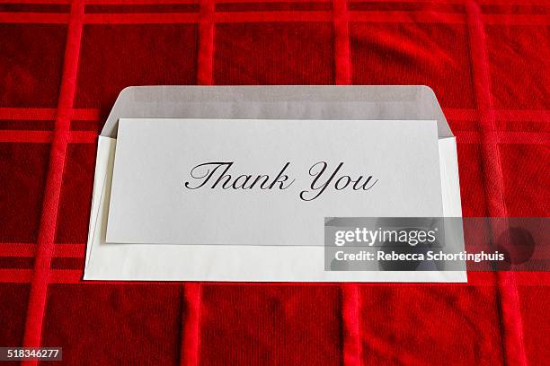 thank you card and envelope on red tablecloth - red card envelope stock pictures, royalty-free photos & images