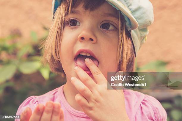 portrait of little girl eating red currants - finger in mouth stock pictures, royalty-free photos & images