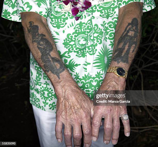 Pearl Harbor survivor, Thomas Michenovich, shows off his wartime tattoos before the start of a ceremony honoring survivors of the Japanese sneak...