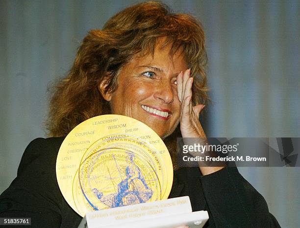 Dr. Mimi Silbert wipes a tear from her eye after receiving the Minerva Award during the California Governor's Conference on Women and Families at the...
