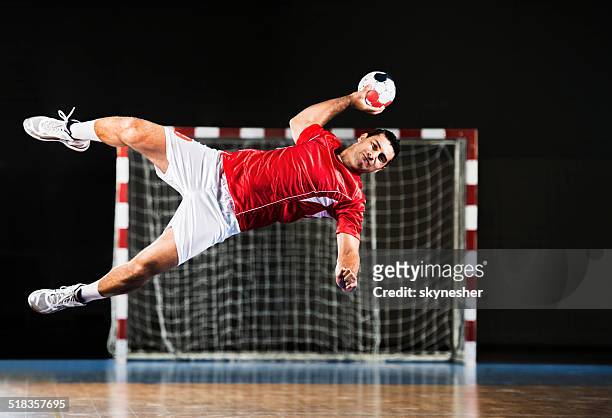 male handball player in action. - handball stock pictures, royalty-free photos & images