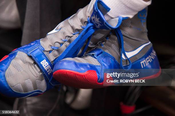 Manny Pacquiao personalized shoes are seen while being interviewed before his media workout at the Wild Card Boxing Club in Hollywood, California...