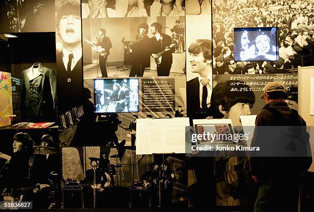 Japanese fan looks at memorabilia from The Beatles at the John Lennon Museum on December 8, 2004 in Saitama, Japan. Fans gathered at the museum to...