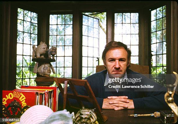 Portrait of American actor Gene Hackman as he sits at a desk, California, 1972.