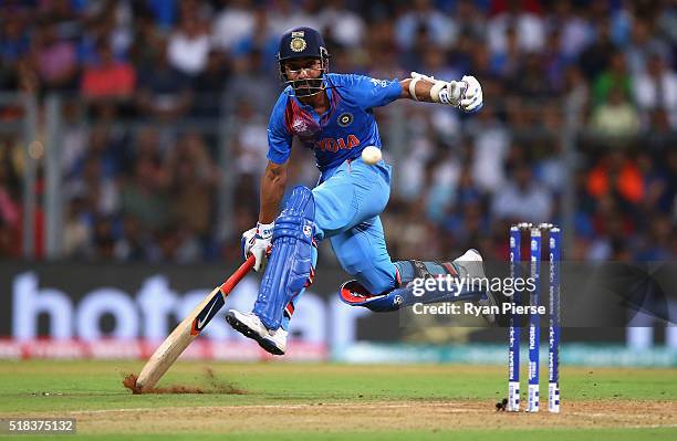 Ajinkya Rahane of India slides his bat to make his ground during the ICC World Twenty20 India 2016 Semi Final match between West Indies and India at...