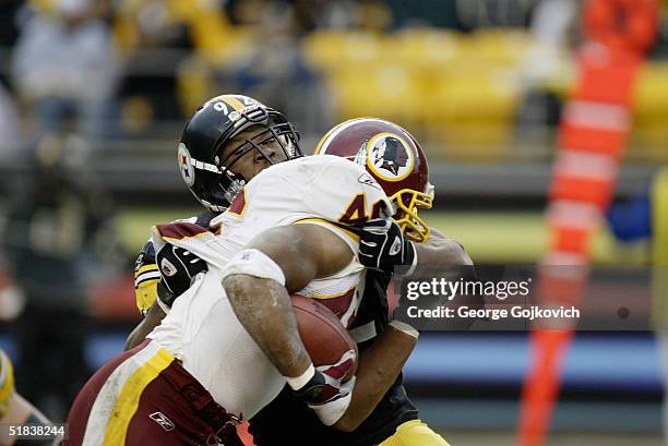Linebacker James Harrison of the Pittsburgh Steelers tackles running back Ladell Betts of the Washington Redskins at Heinz Field on November 28, 2004...