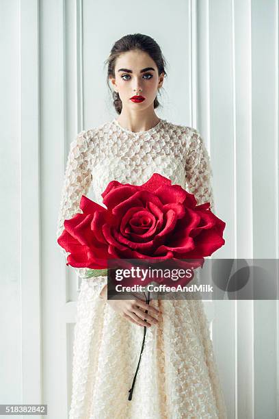 studio shot of young beautiful bride with big rose - big cool attitude stock pictures, royalty-free photos & images