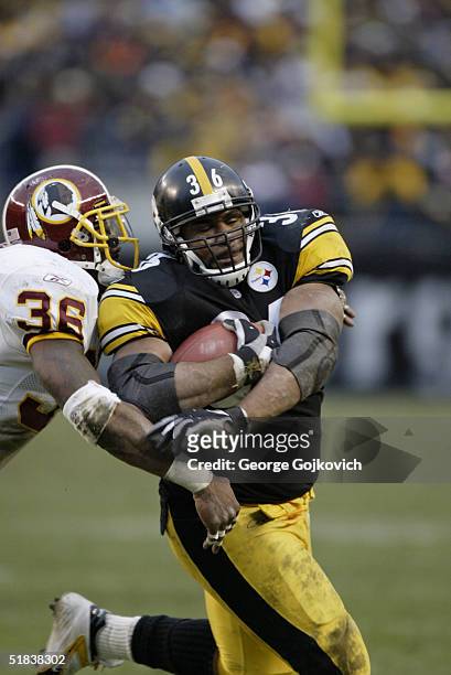 Running back Jerome Bettis of the Pittsburgh Steelers tries to push away safety Sean Taylor of the Washington Redskins at Heinz Field on November 28,...