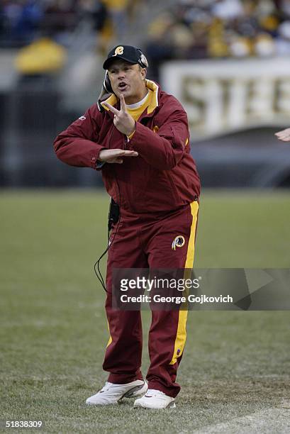 Assistant head coach/defense Gregg Williams of the Washington Redskins signals to his players during a game against the Pittsburgh Steelers at Heinz...