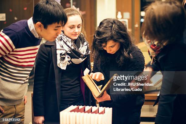 College students at the Johns Hopkins University examine books in a Special Collections library, 2016. Courtesy Eric Chen. .
