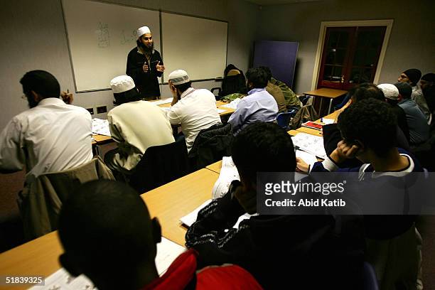 British muslim teacher, Mujahid Ali , teaches British muslim students an Arabic language lesson, during an evening class in Ebrahim Community College...