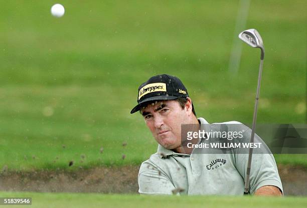 Australian golfer Craig Parry chips out of a bunker and into the hole for a birdie on the 16th during the first round of the Australian Masters at...