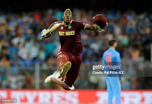 Andre Russell of the West Indies celebrates after winning the ICC World Twenty20 India 2016 Semi Final match between India and West Indies on March...