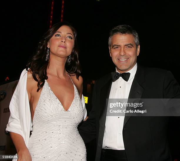 Actor George Clooney with model Lisa Snowdon arrive to the Warner Bros. Premiere of the film "Ocean's Twelve" at Grauman's Chinese Theatre December...