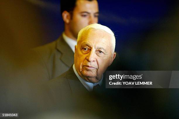 Israeli Prime Minister Ariel Sharon looks on 09 December 2004 in Tel Aviv, as his Likud party members vote on whether to allow the Labour party, the...