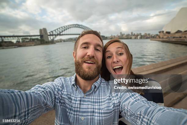 young couple in sydney harbour, take a selfie portrait - sydney opera house people stock pictures, royalty-free photos & images