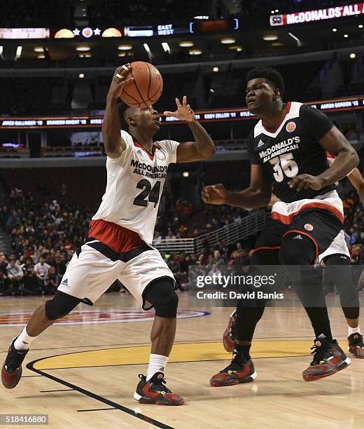 Alterique Gilbert of the West team drives around Udoka Azubuike of the East team during the 2016 McDonalds's All American Game on March 30, 2016 at...