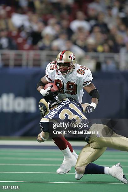 Curtis Conway of the San Francisco 49ers runs with the ball against Adam Archuleta of the St. Louis Rams at the Edward Jones Dome on December 5, 2004...