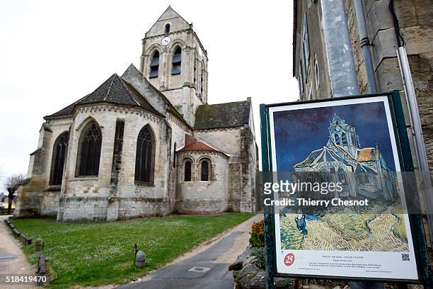 The Auvers Church stands behind a replica of "The Church at Auvers" by Dutch painter Vincent Van Gogh depicting the church on March 31, 2016 in...