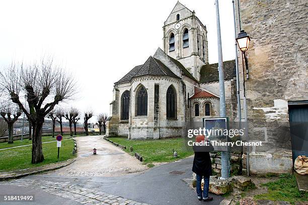 The Auvers Church stands behind a replica of "The Church at Auvers" by Dutch painter Vincent Van Gogh depicting the church on March 31, 2016 in...