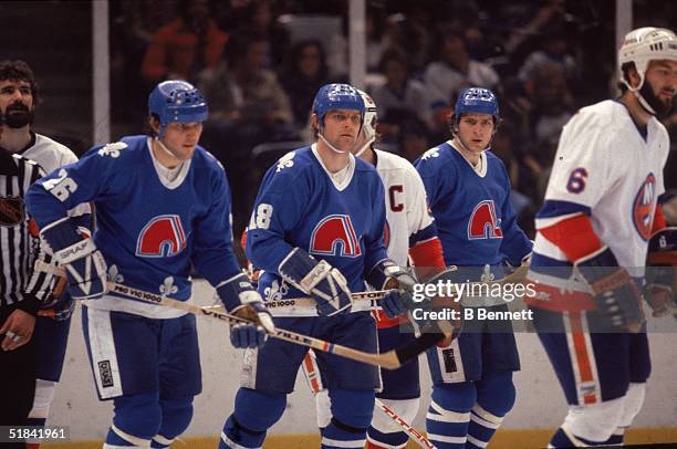 Czech ice hockey playing brothers, Peter Stastny , Marian Stastny , and Anton Stastny, of the Quebec Nordiques on the ice in a game against the New...