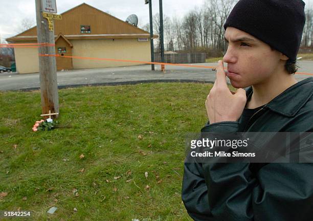 Jeremy Spencer smokes a cigarette outside the Alrosa Villa nightclub the day after a gunman fired on the band Damageplan, December 9, 2004 in...