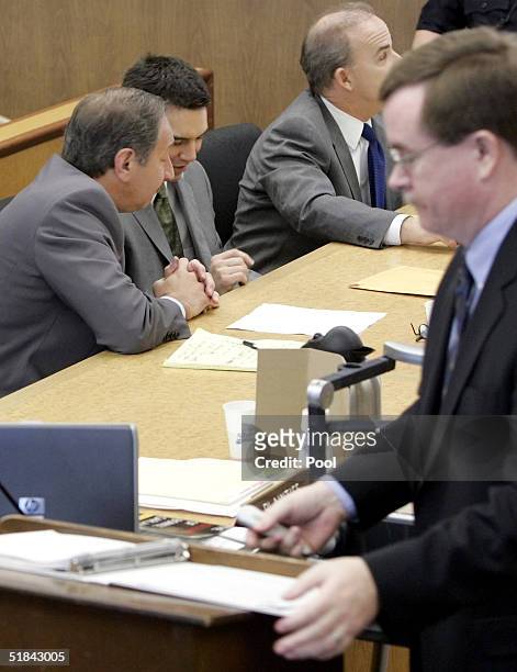 Attorney Mark Geragos and his client, convicted double murderer Scott Peterson , confer as Deputy District attorney Dave Harris closes for the...
