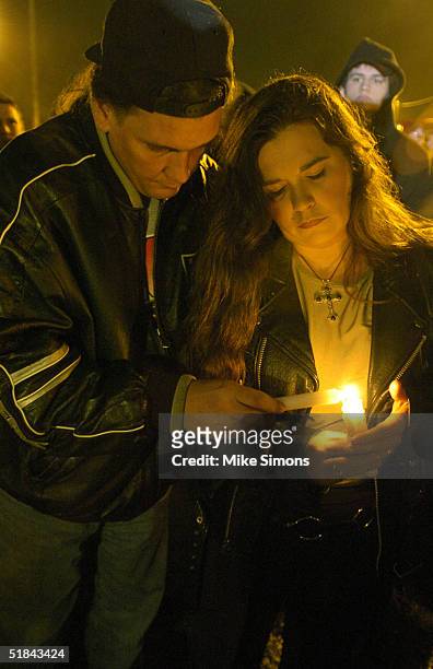 Heather and David Ansley light candles at an impromptu vigil outside of the Alrosa Villa Club on December 9, 2004 in Columbus, Ohio. According to...