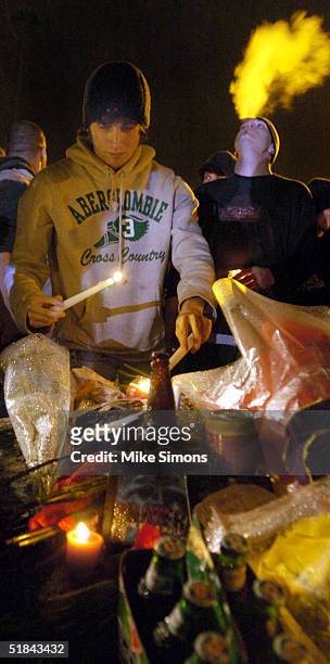 Mourner places a candle at a makeshift memorial outside of the Alrosa Villa Club on December 9, 2004 in Columbus, Ohio. According to authorities, a...