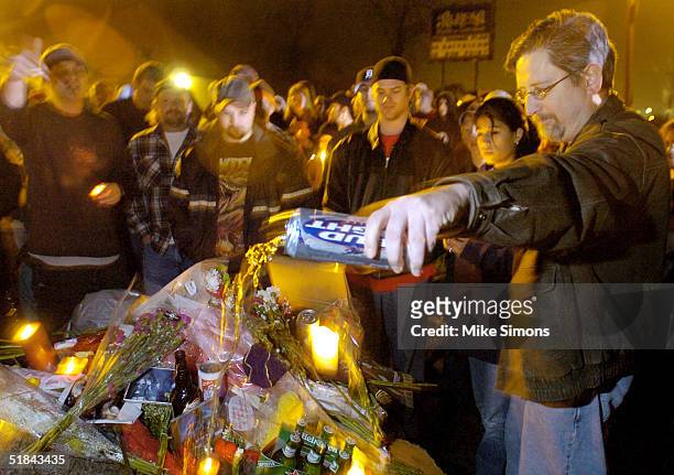 David Manning pours beer on a makeshift memorial outside of the Alrosa Villa Club on December 9, 2004 in Columbus, Ohio. According to authorities, a...