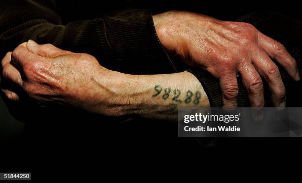 Auschwitz survivor Mr. Leon Greenman, prison number 98288, displays his number tattoo on December 9, 2004 at the Jewish Museum in London, England....