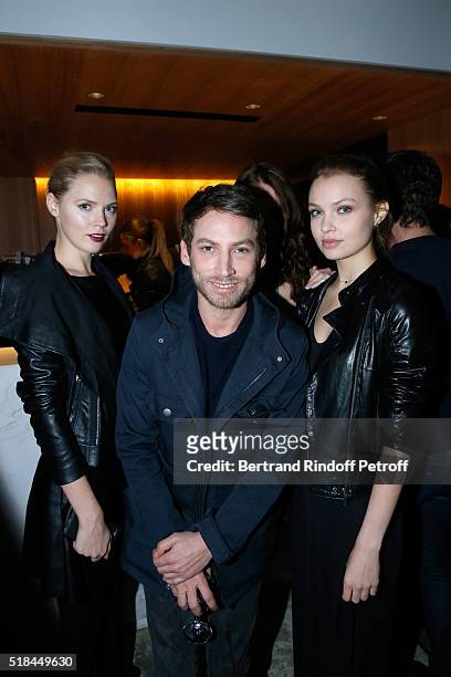 Ora Ito standing between Models attend the 'Guy Bourdin - Portraits' - Exhibition Opening and Cocktail at Studio des Acacias on March 31, 2016 in...