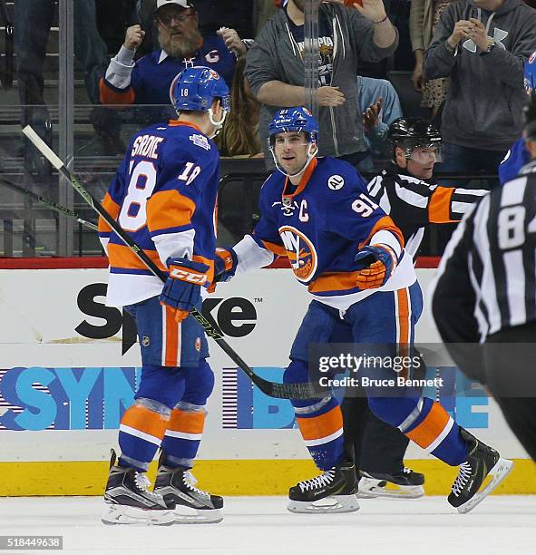 John Tavares of the New York Islanders celebrates his second goal of the first period at 18:32 against the Columbus Blue Jackets and is joined by...