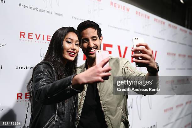 Sami Slimani and Anuthida Ploypetch attend the REVIEW by Sami Slimani Capsule Collection launch party on March 31, 2016 in Duesseldorf, Germany.