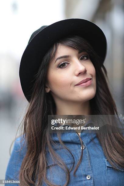 Sarah Benziane , is wearing a Zara blue dress and a vintage black hat during a street style session, in the 1st quarter of Paris, on March 31, 2016...