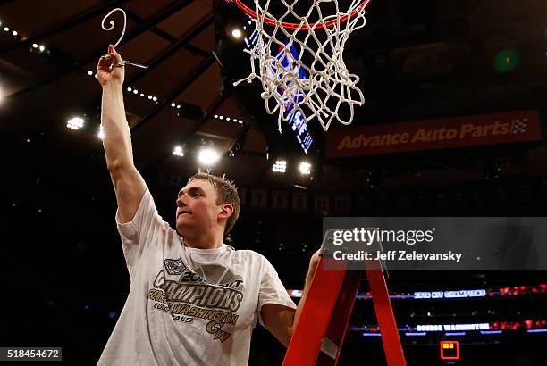 Tyler Cavanaugh of the George Washington Colonials cuts down the net after winning Most Outstanding Player during win over Valparaiso Crusaders...