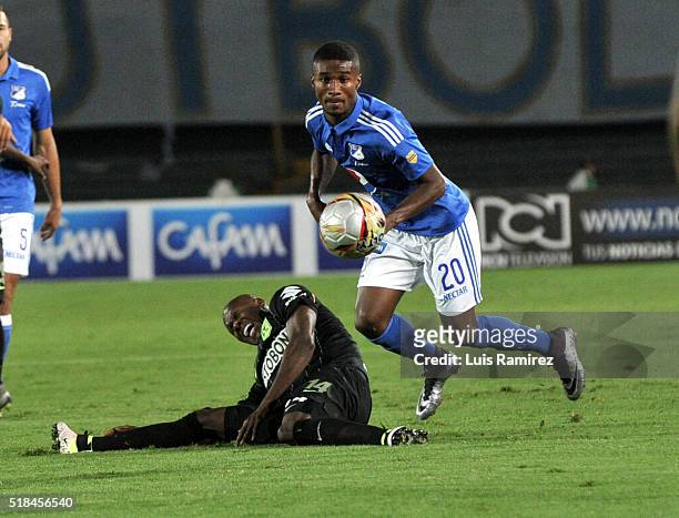 Hector Quiñonez of Millonarios vies for the ball with Victor Ibarbo of Atletico Nacional, during a match between Millonarios and Atletico Nacional as...