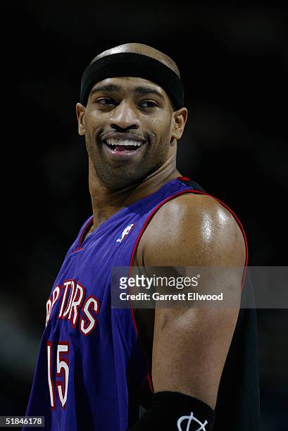 Vince Carter of the Toronto Raptors smiles during the game against the Denver Nuggets on November 17, 2004 at Pepsi Center in Denver, Colorado. The...