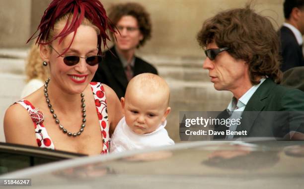 Rolling Stones lead singer Mick Jagger and model Jerry Hall with baby Gabriel attend the wedding of Princess Maria-Theodora 'Dora' Loewenstein to...