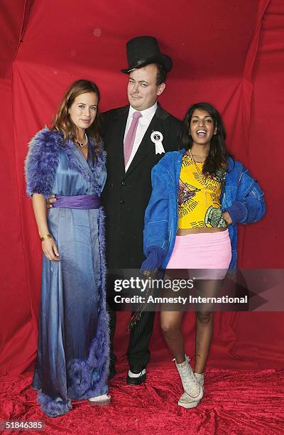 Jade Jagger and architect Tom Bartlett and their guest pose in a Victorian-themed booth at the "Amnesty International - VIP Burlesque Party" at...