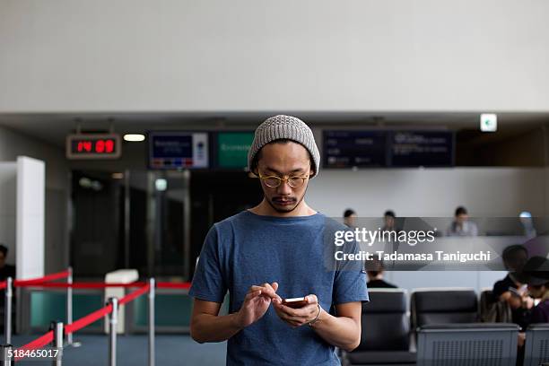 man using smart phone - airport man stock pictures, royalty-free photos & images