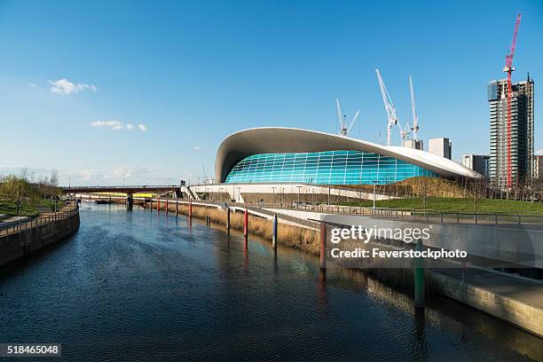 view along the canal showing london olympic aquatics centre - aquatic center stock pictures, royalty-free photos & images