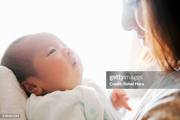 mother taking care of her baby - japanese baby photos et images de collection