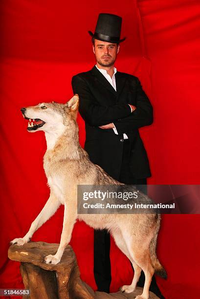 Presenter Jamie Theakston poses in a Victorian-themed booth at the "Amnesty International - VIP Burlesque Party" at Canvas on November 25, 2004 in...