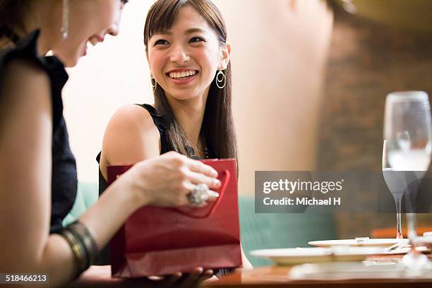 present from friend - asian couple dinner stock pictures, royalty-free photos & images